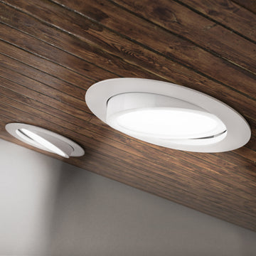 Seen on edge, the IC Rated Slim Gimbal with flexible optic is shown here without the included junction box and cabling. You can clearly note the spring clips that hold this thin profile ceiling light in position. The gimbal is adjustable to aim the light where you need it. Choose color temperature from 5 selections of white light with the slider on the junction box (not pictured here). This 6-inch wide downlight is quickly installed in the ceiling and offers instant on, dimmable downlight.
